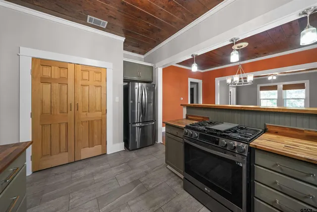 a kitchen with stainless steel appliances a stove and a refrigerator