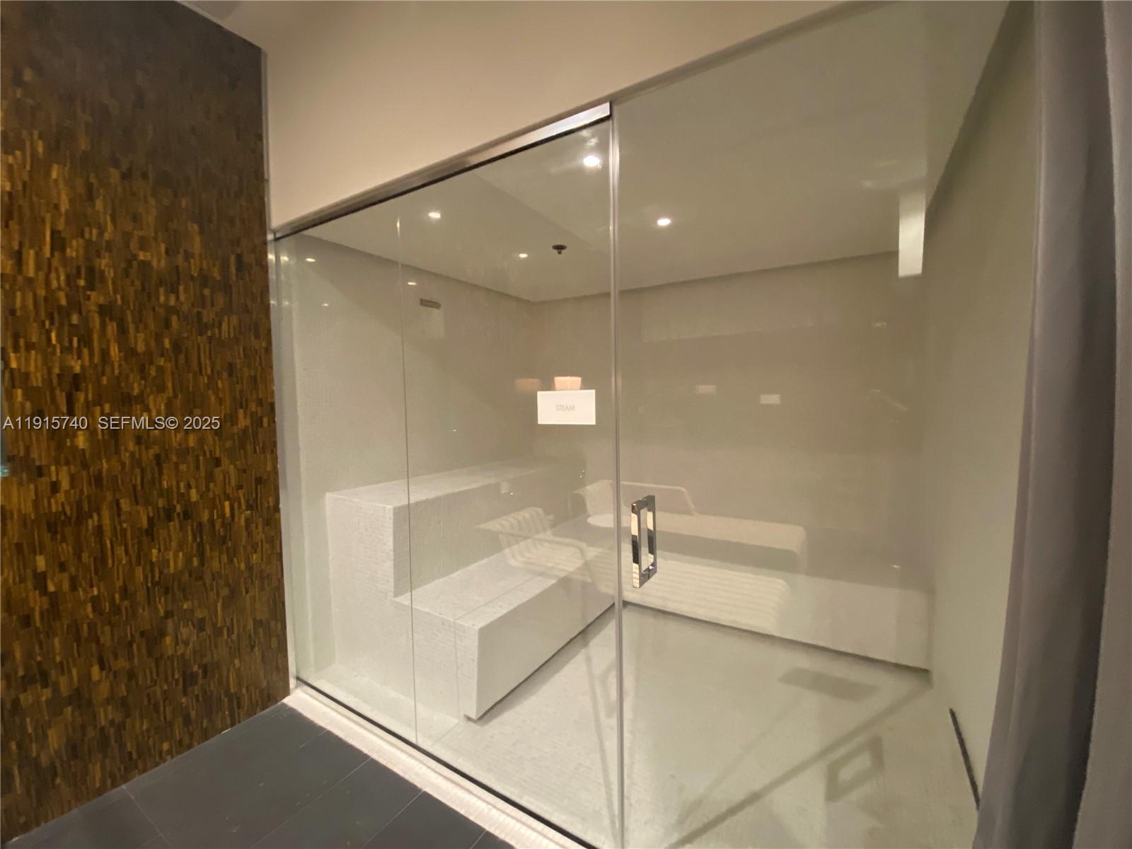 2000 Metropica Way, Unit 2104 Sunrise, FL 33323 - Photo 25 of 62 a bathroom with a shower and a glass door