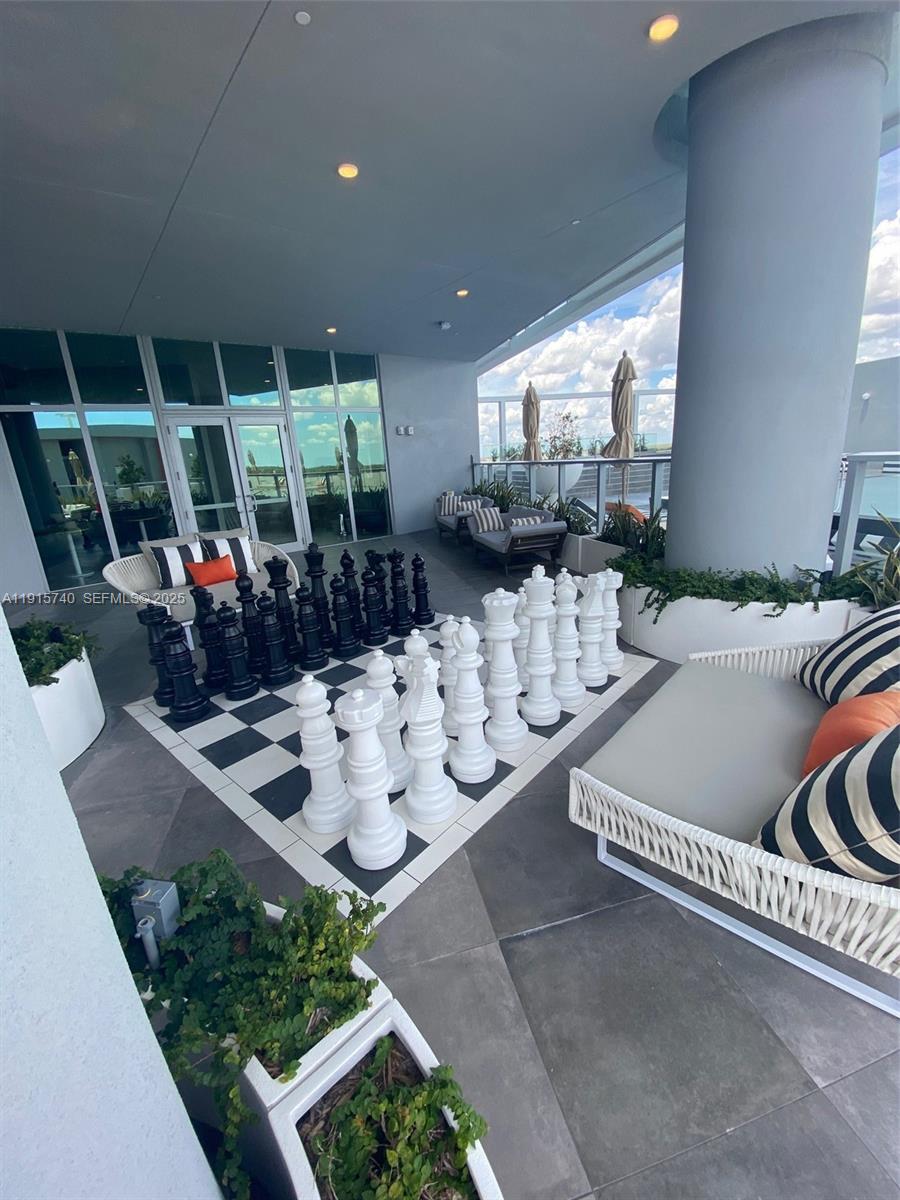 2000 Metropica Way, Unit 2104 Sunrise, FL 33323 - Photo 34 of 62 a living room with furniture and a floor to ceiling window