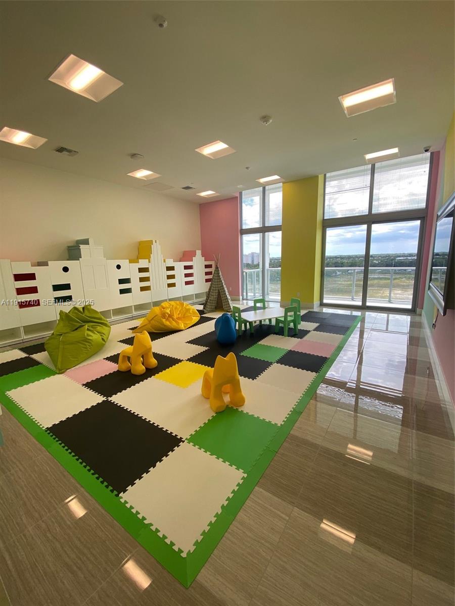 2000 Metropica Way, Unit 2104 Sunrise, FL 33323 - Photo 39 of 62 a room with lots of chairs and a table