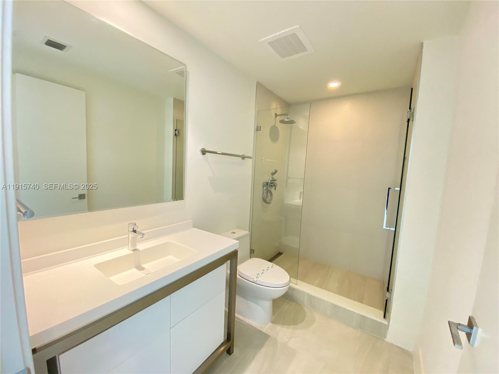 2000 Metropica Way, Unit 2104 Sunrise, FL 33323 - Photo 9 of 62 a bathroom with a sink a toilet and shower