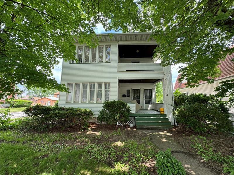 2212 Highland Avenue, Unit 2 New Castle, PA 16105 - Photo 1 of 9 a front view of a house with garden