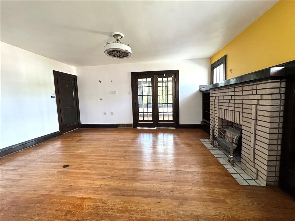 2212 Highland Avenue, Unit 2 New Castle, PA 16105 - Photo 3 of 9 an empty room with wooden floor and windows