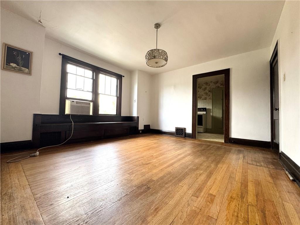 2212 Highland Avenue, Unit 2 New Castle, PA 16105 - Photo 4 of 9 a view of a livingroom with wooden floor and windows