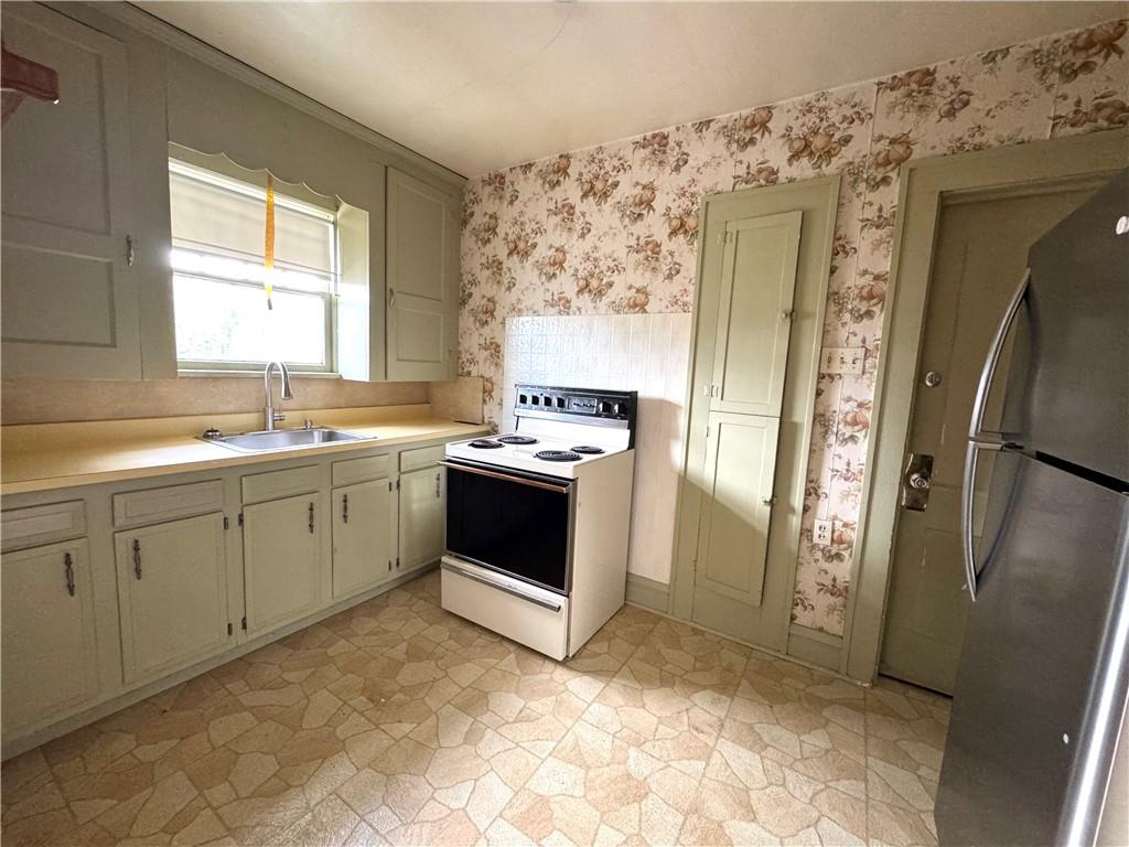 2212 Highland Avenue, Unit 2 New Castle, PA 16105 - Photo 5 of 9 a kitchen with stainless steel appliances a stove a sink and a refrigerator