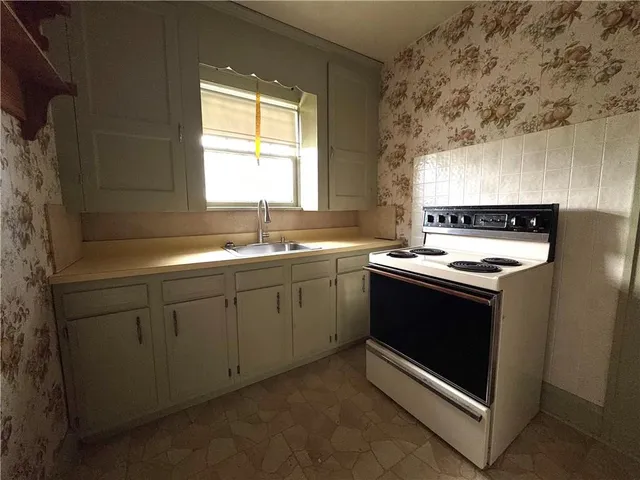 a kitchen with a sink stove and window