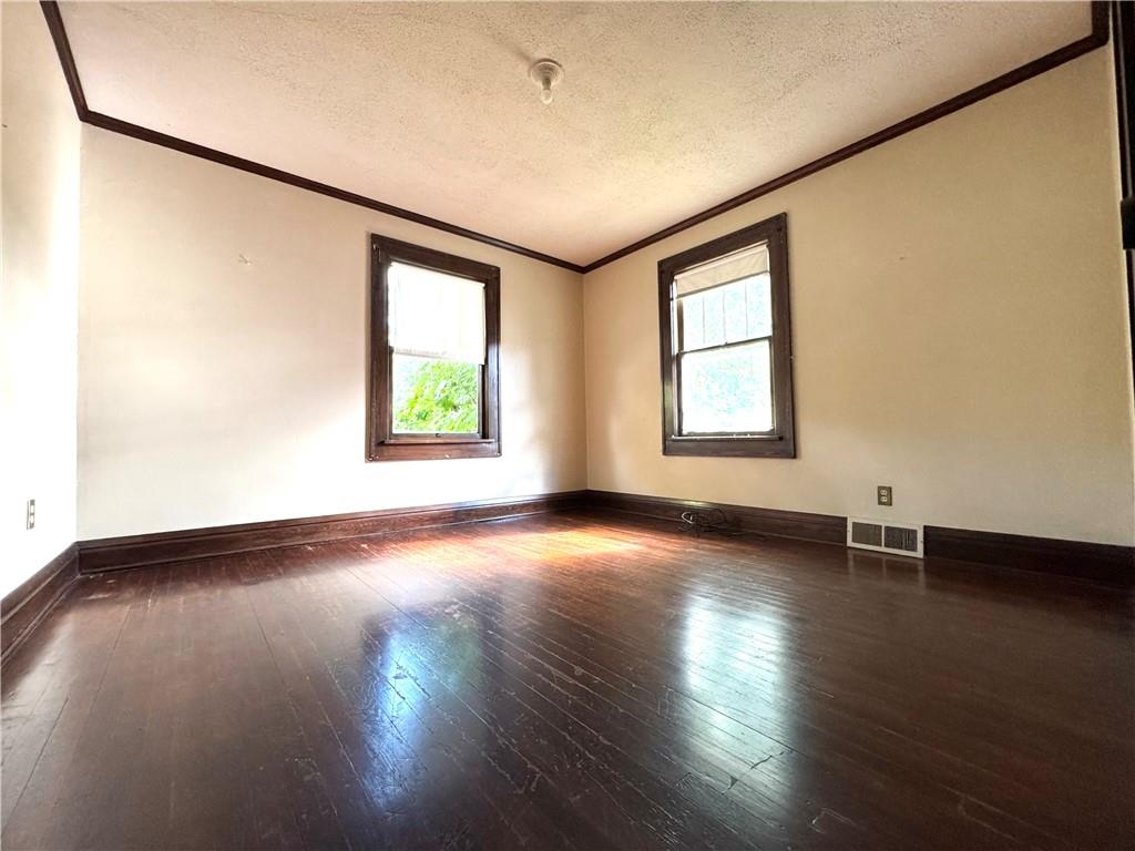 2212 Highland Avenue, Unit 2 New Castle, PA 16105 - Photo 9 of 9 an empty room with wooden floor and windows