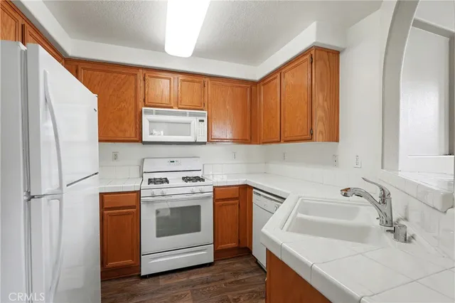 a kitchen with a sink stove and microwave