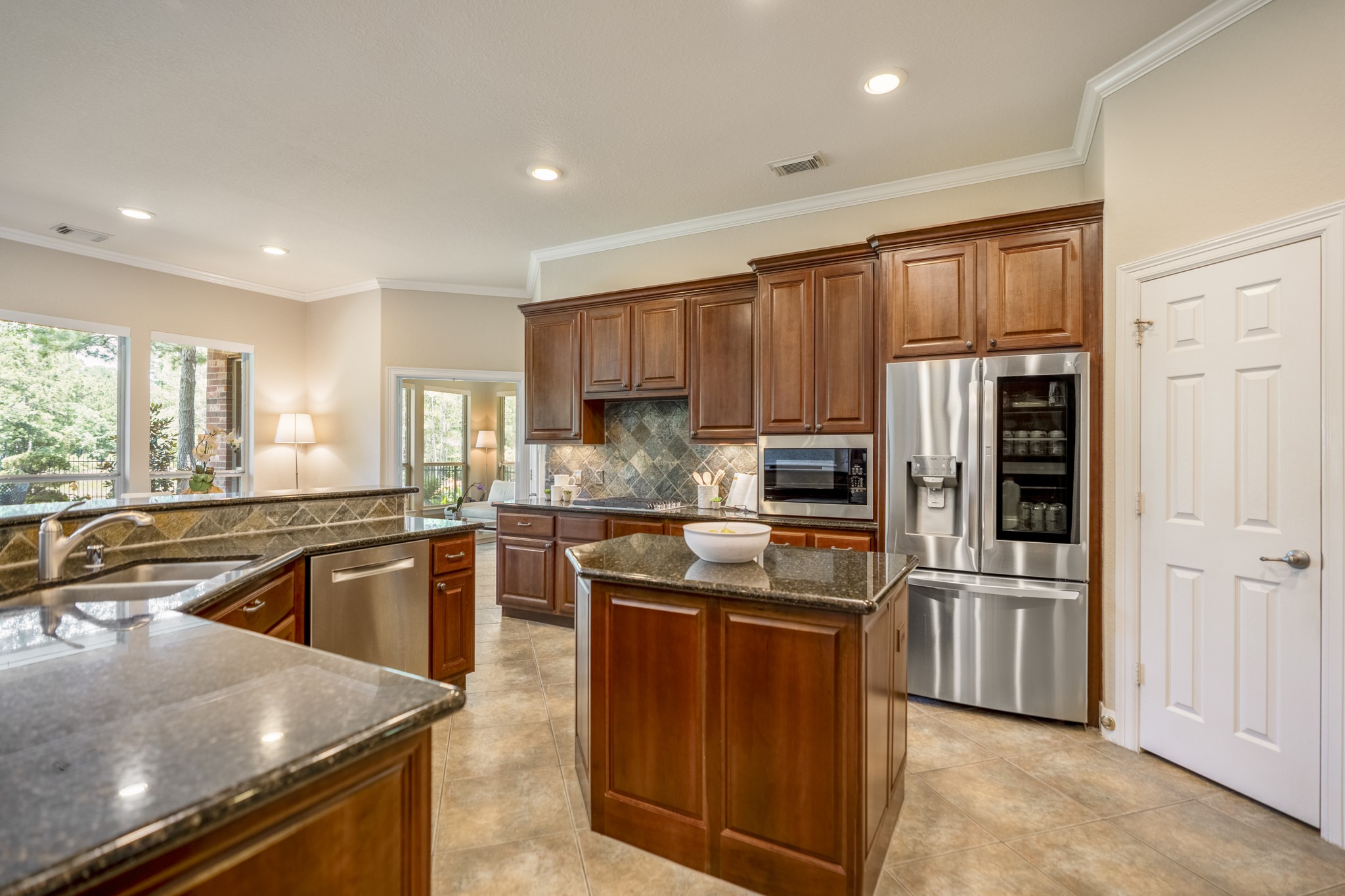 67 North Pentenwell Circle Spring, TX 77382 - Photo 14 of 50 a kitchen with stainless steel appliances granite countertop a refrigerator stove and sink