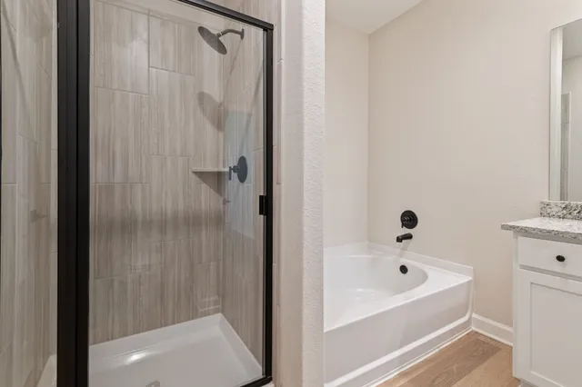 a bathroom with a bathtub and shower