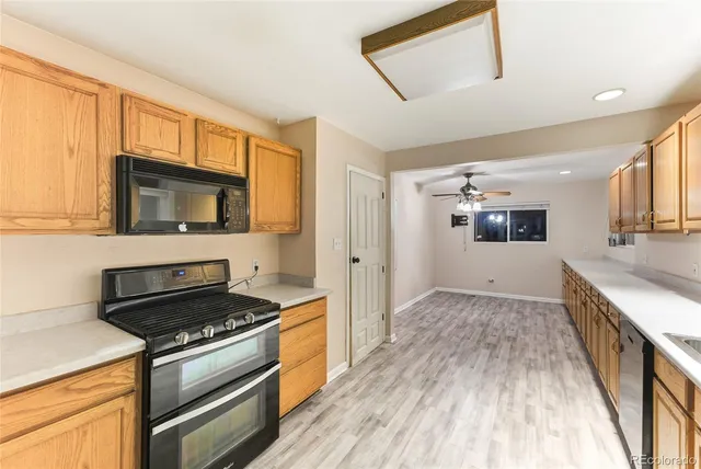 a kitchen with granite countertop a stove and a sink