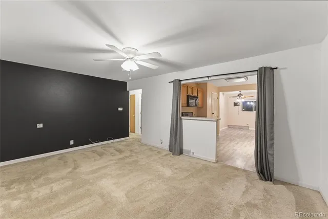 a view of a big room with closet and a chandelier fan