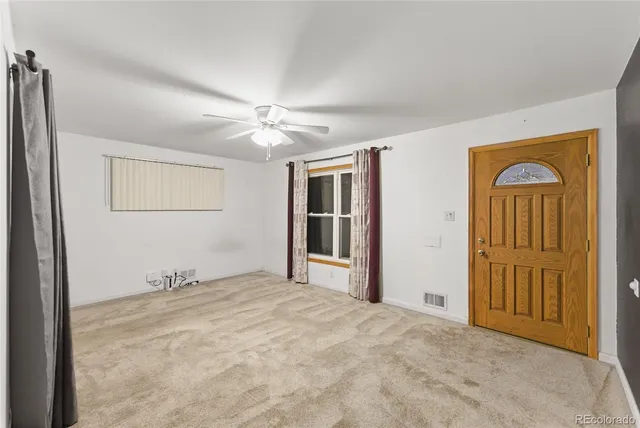 an empty room with windows and closet