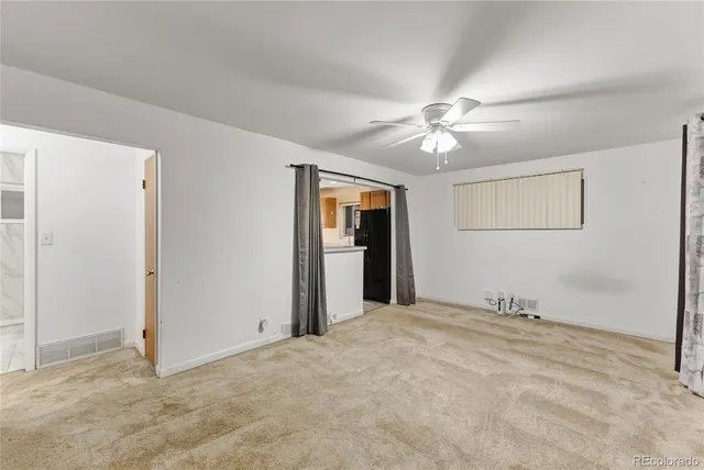 a view of an empty room with a ceiling fan