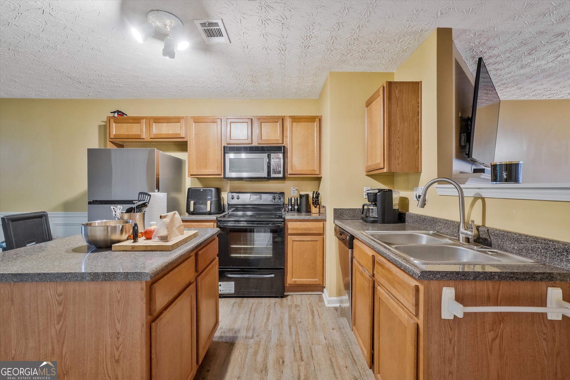 2870 Vining Ridge Terrace Decatur, GA 30034 - Photo 11 of 34 a kitchen with stainless steel appliances granite countertop a sink stove and refrigerator