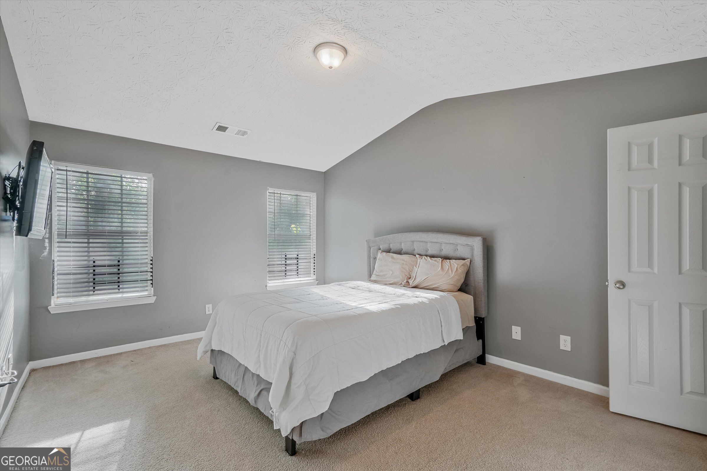 2870 Vining Ridge Terrace Decatur, GA 30034 - Photo 22 of 34 a bed sitting in a spacious bedroom next to a window and a dresser