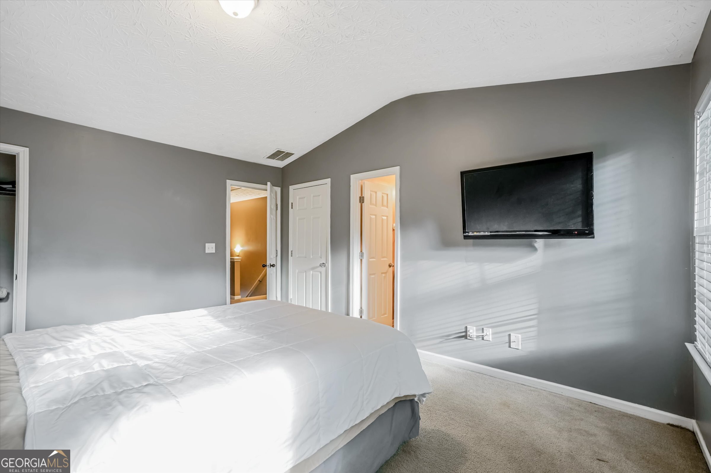 2870 Vining Ridge Terrace Decatur, GA 30034 - Photo 27 of 34 a bedroom with a bed and a flat screen tv