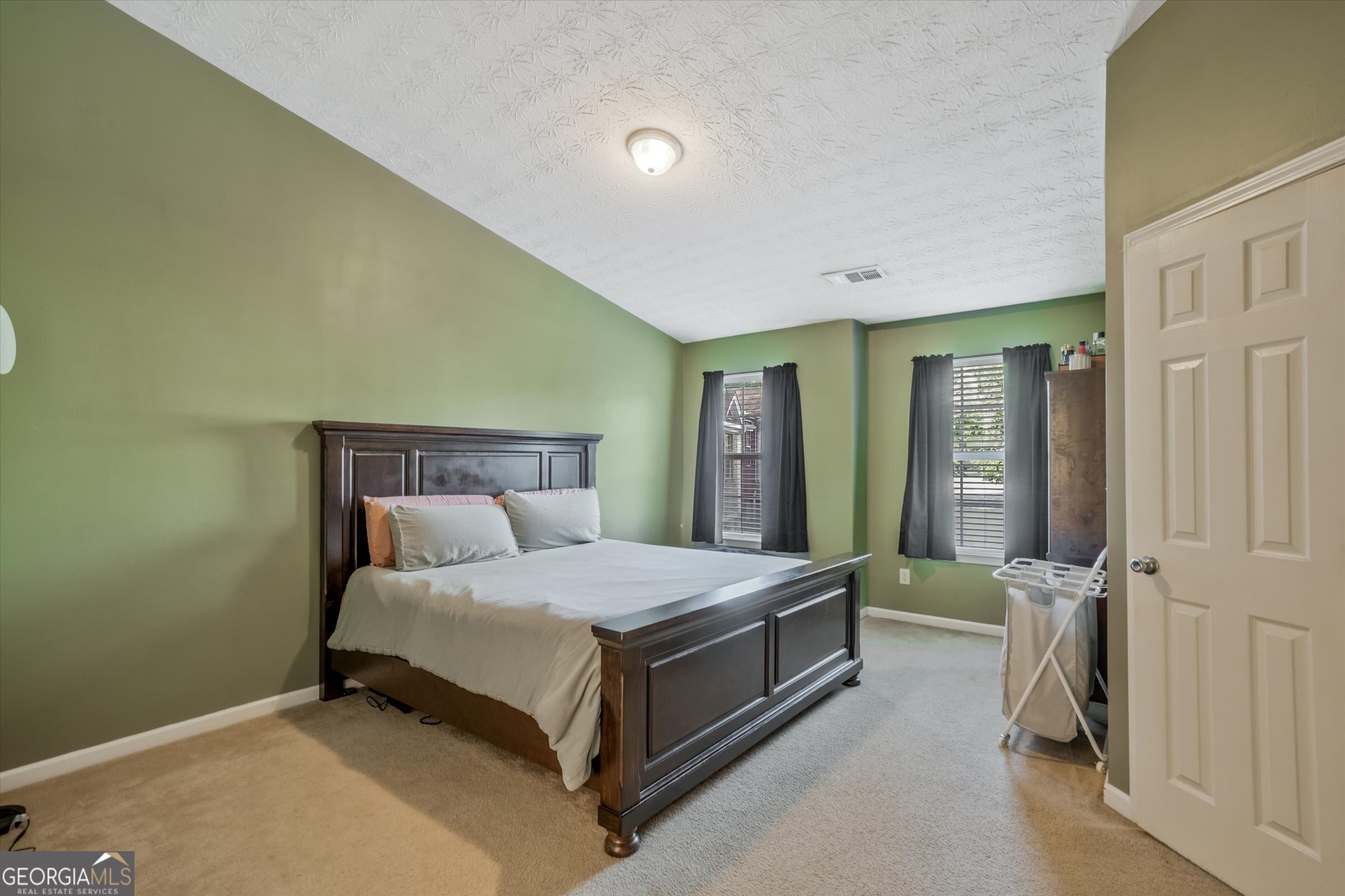 2870 Vining Ridge Terrace Decatur, GA 30034 - Photo 30 of 34 a bedroom with a bed and a mirror