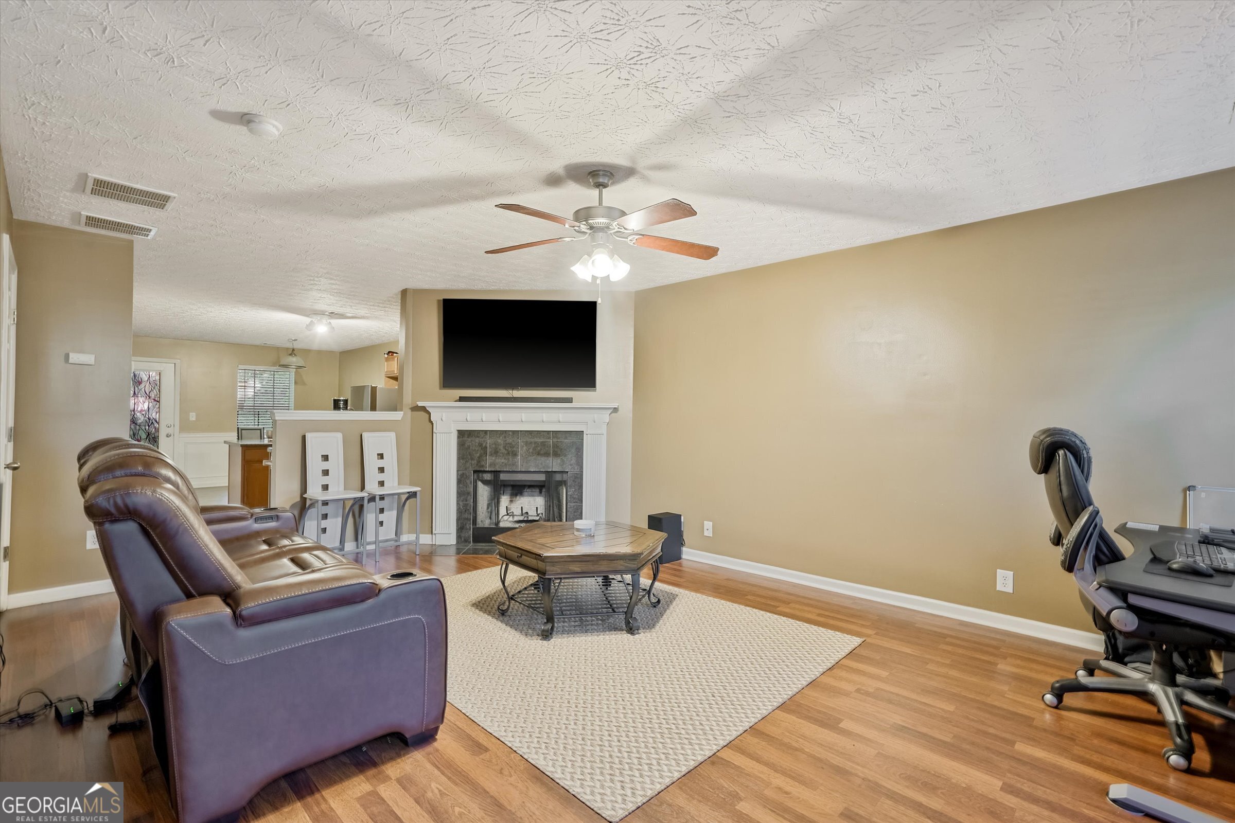 2870 Vining Ridge Terrace Decatur, GA 30034 - Photo 3 of 34 a living room with furniture a fireplace and a flat screen tv