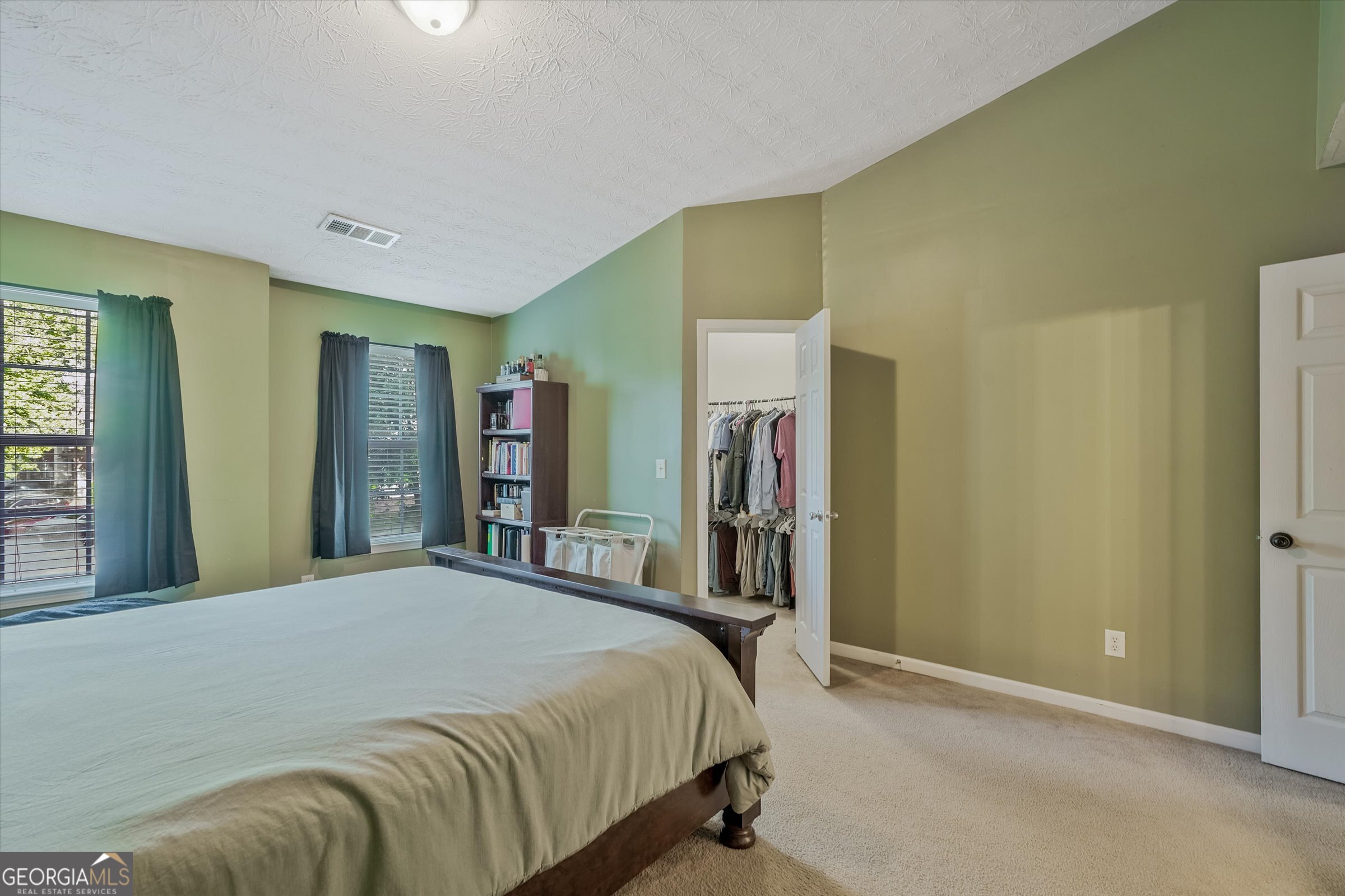 2870 Vining Ridge Terrace Decatur, GA 30034 - Photo 32 of 34 a bedroom with a bed and a large mirror