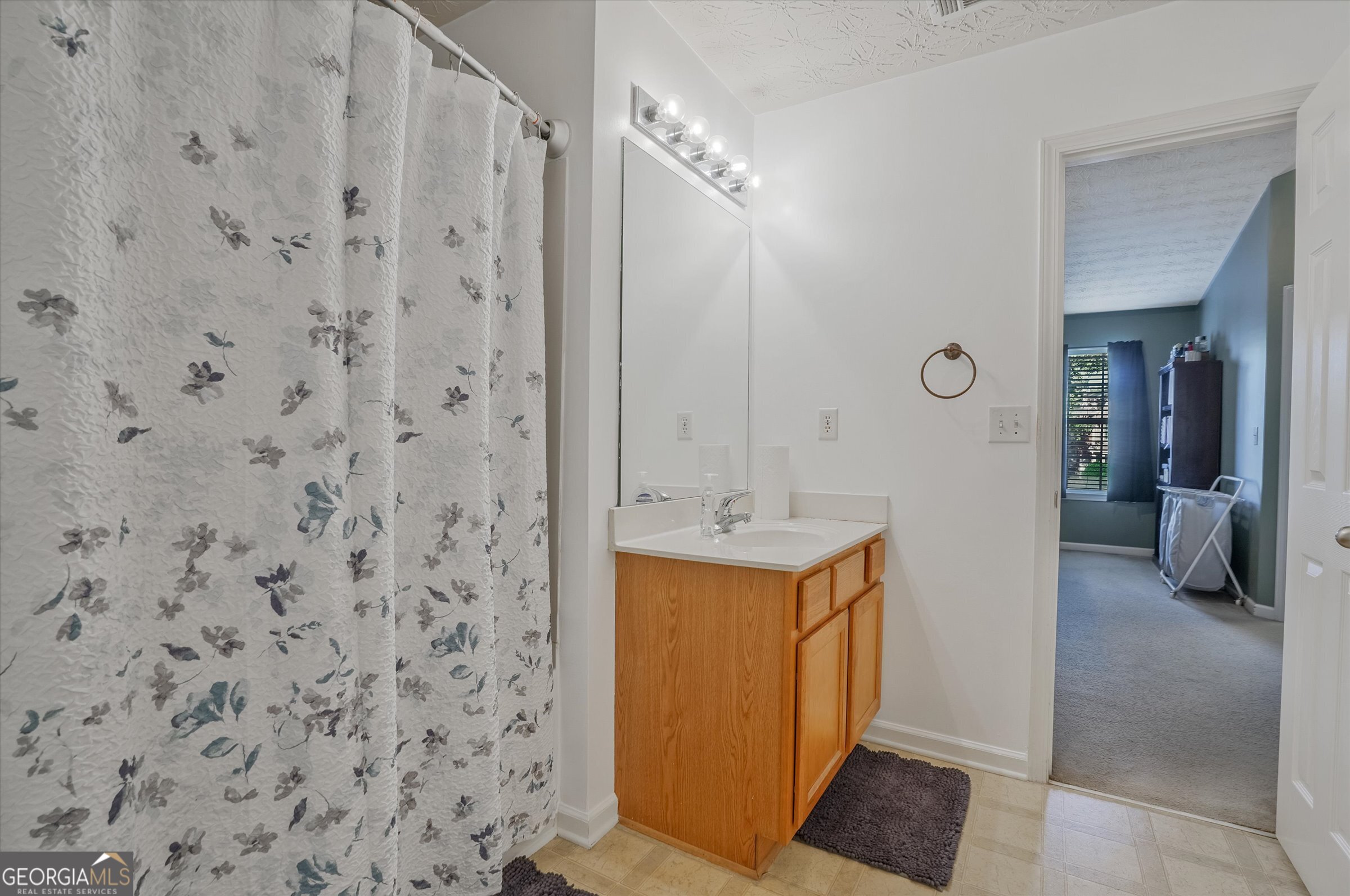 2870 Vining Ridge Terrace Decatur, GA 30034 - Photo 34 of 34 a bathroom with a sink a mirror and shower