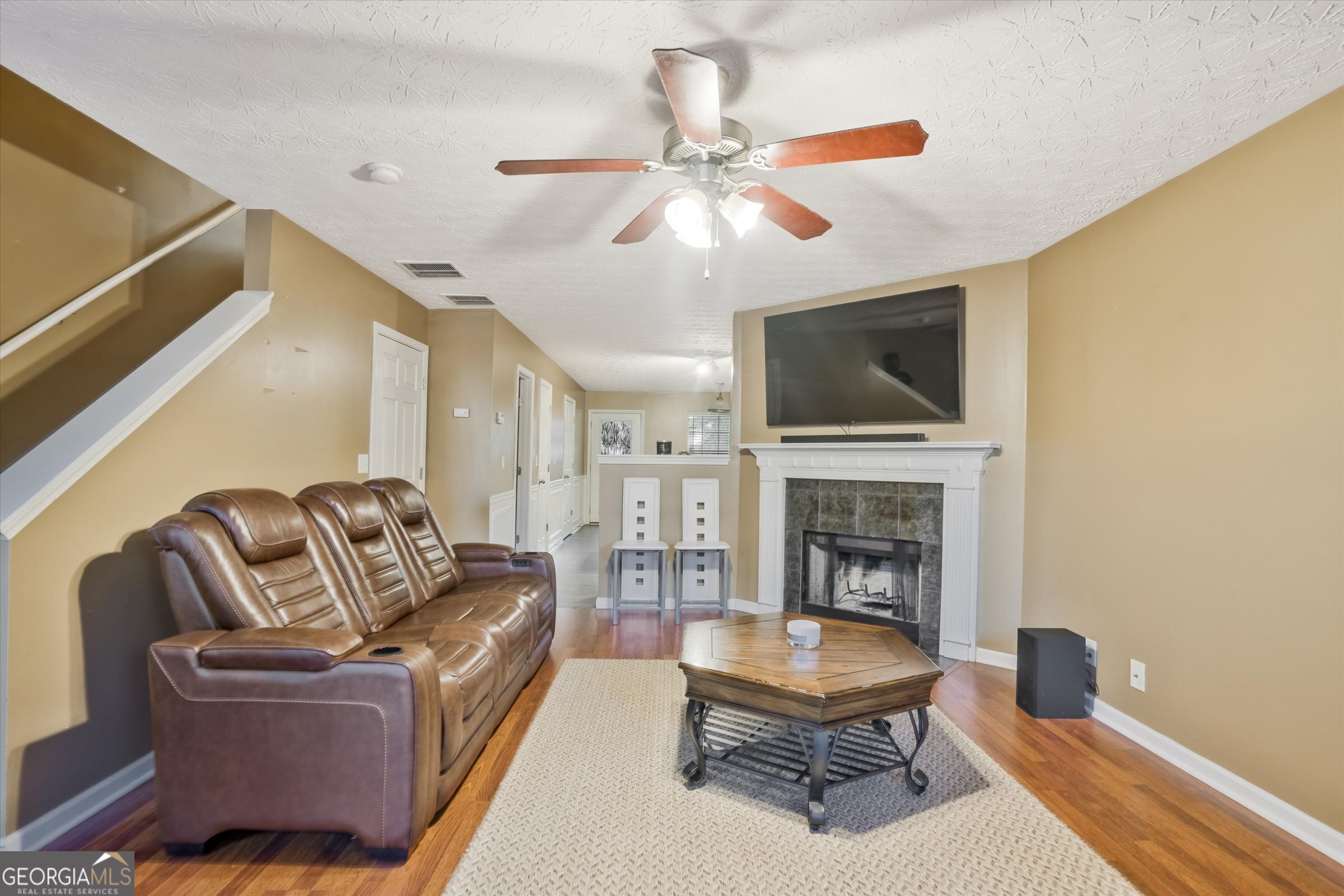 2870 Vining Ridge Terrace Decatur, GA 30034 - Photo 4 of 34 a living room with furniture a fireplace and a flat screen tv