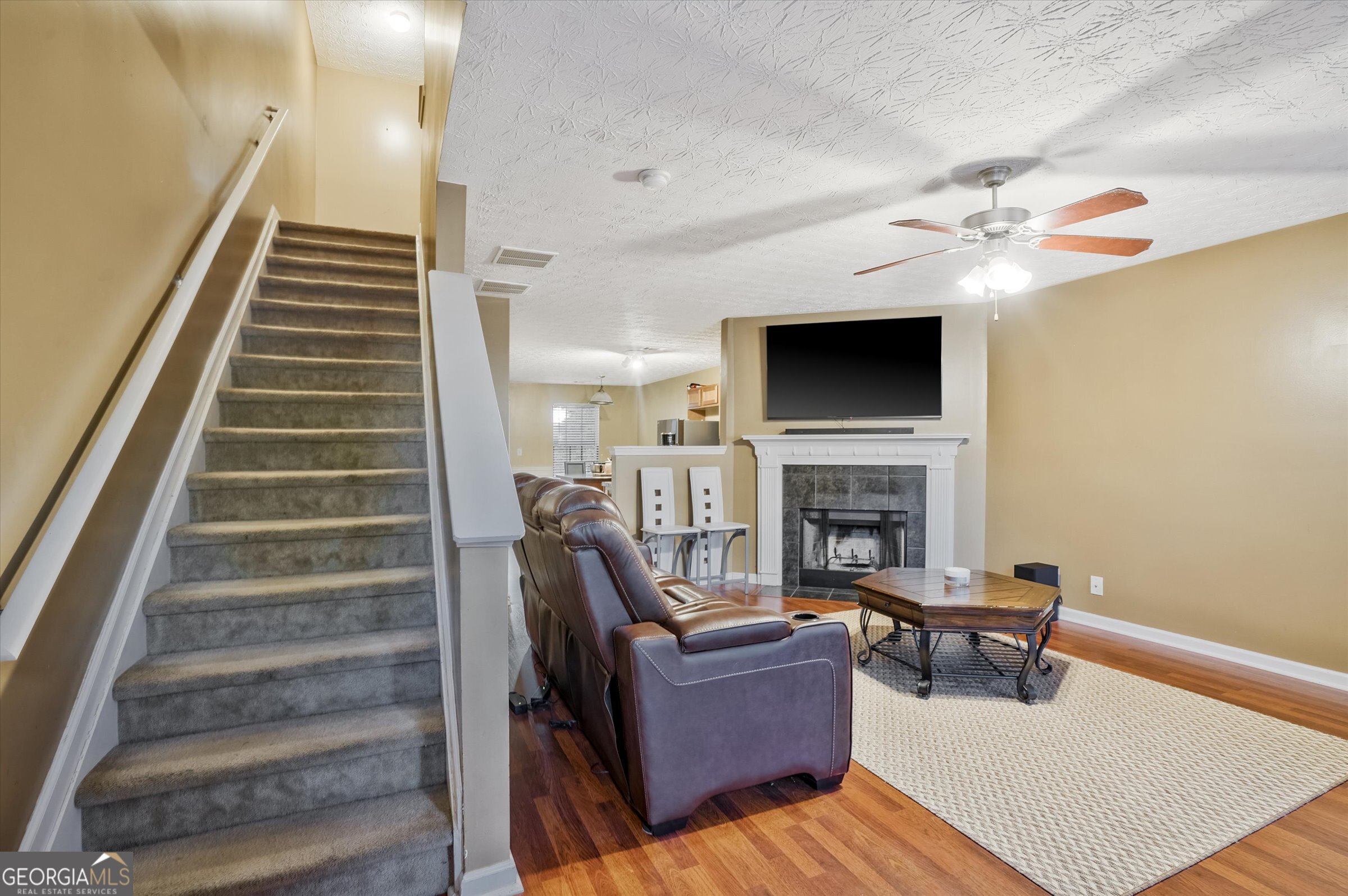 2870 Vining Ridge Terrace Decatur, GA 30034 - Photo 7 of 34 a living room with furniture a fireplace and a flat screen tv