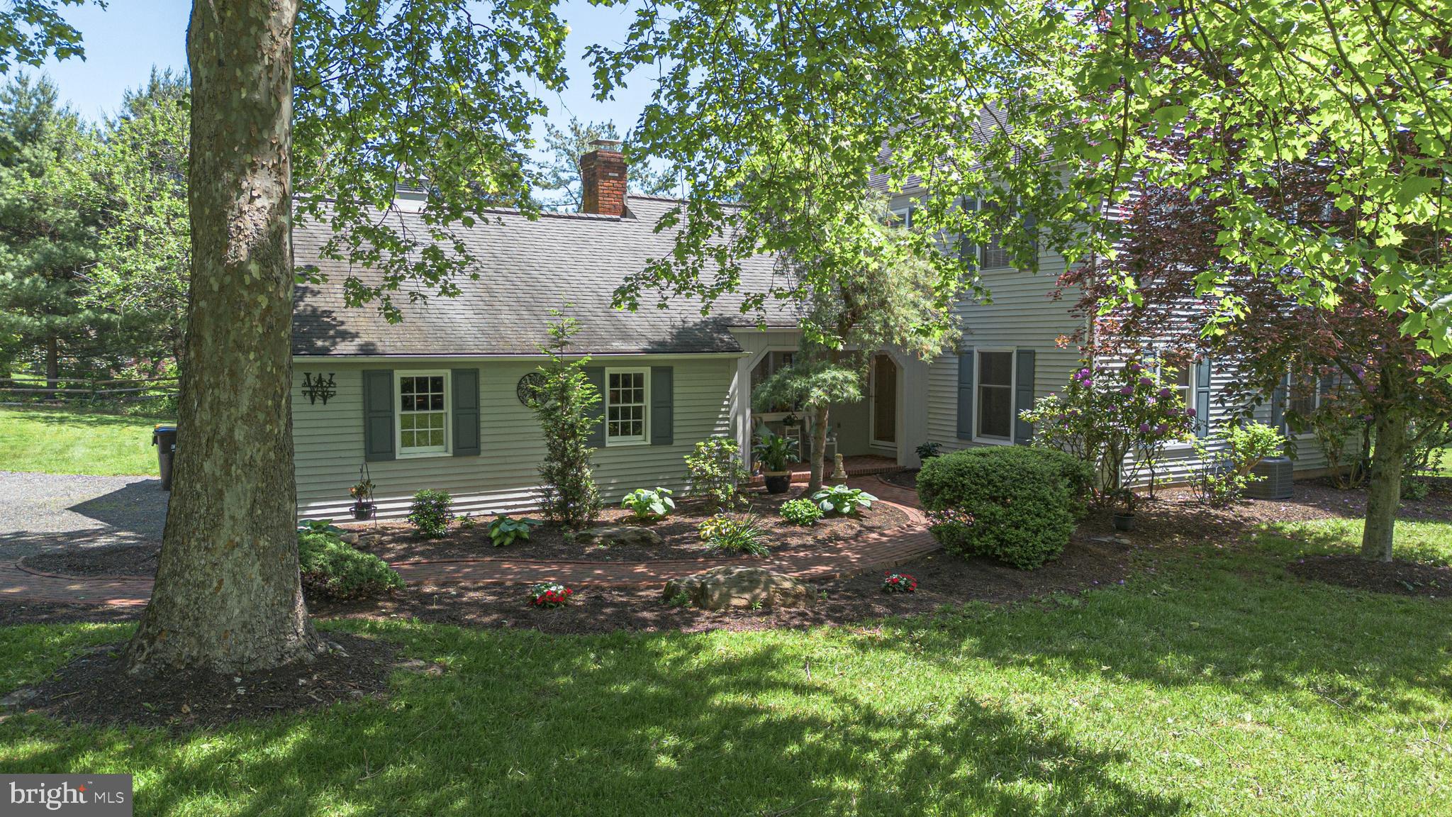 a front view of a house with a garden and porch