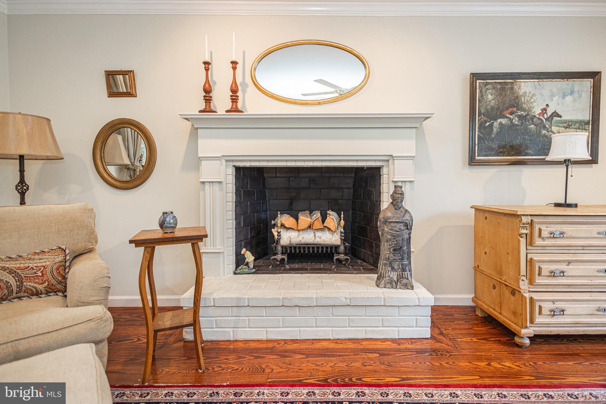 3048 Aquetong Road New Hope, PA 18938 - Photo 11 of 30 a living room with furniture a clock and a fireplace