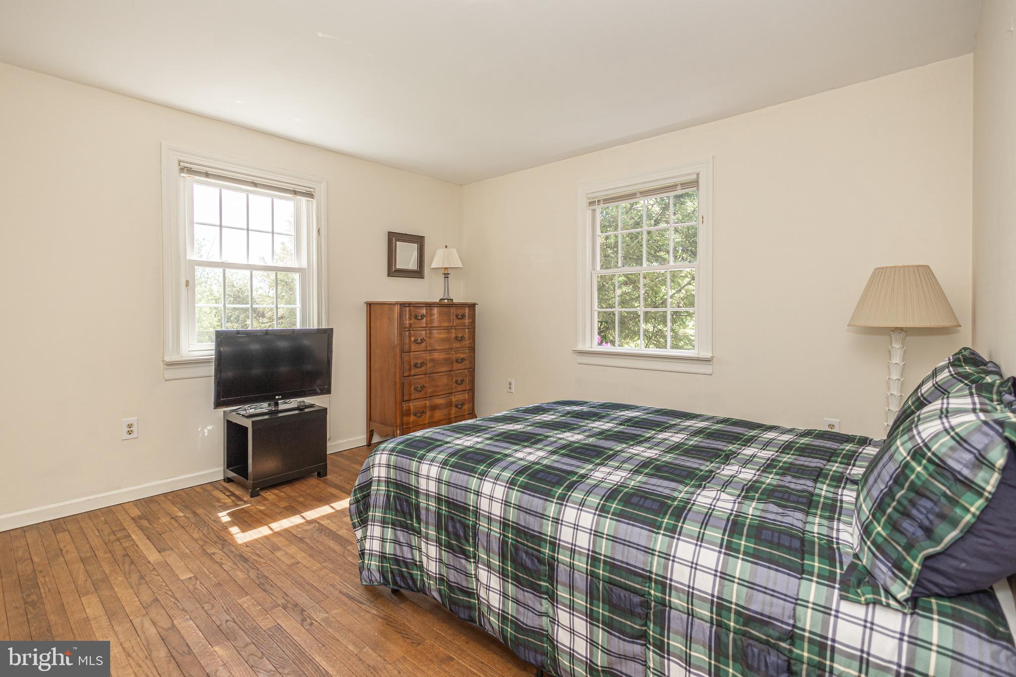3048 Aquetong Road New Hope, PA 18938 - Photo 20 of 30 a bedroom with a bed and wooden floor