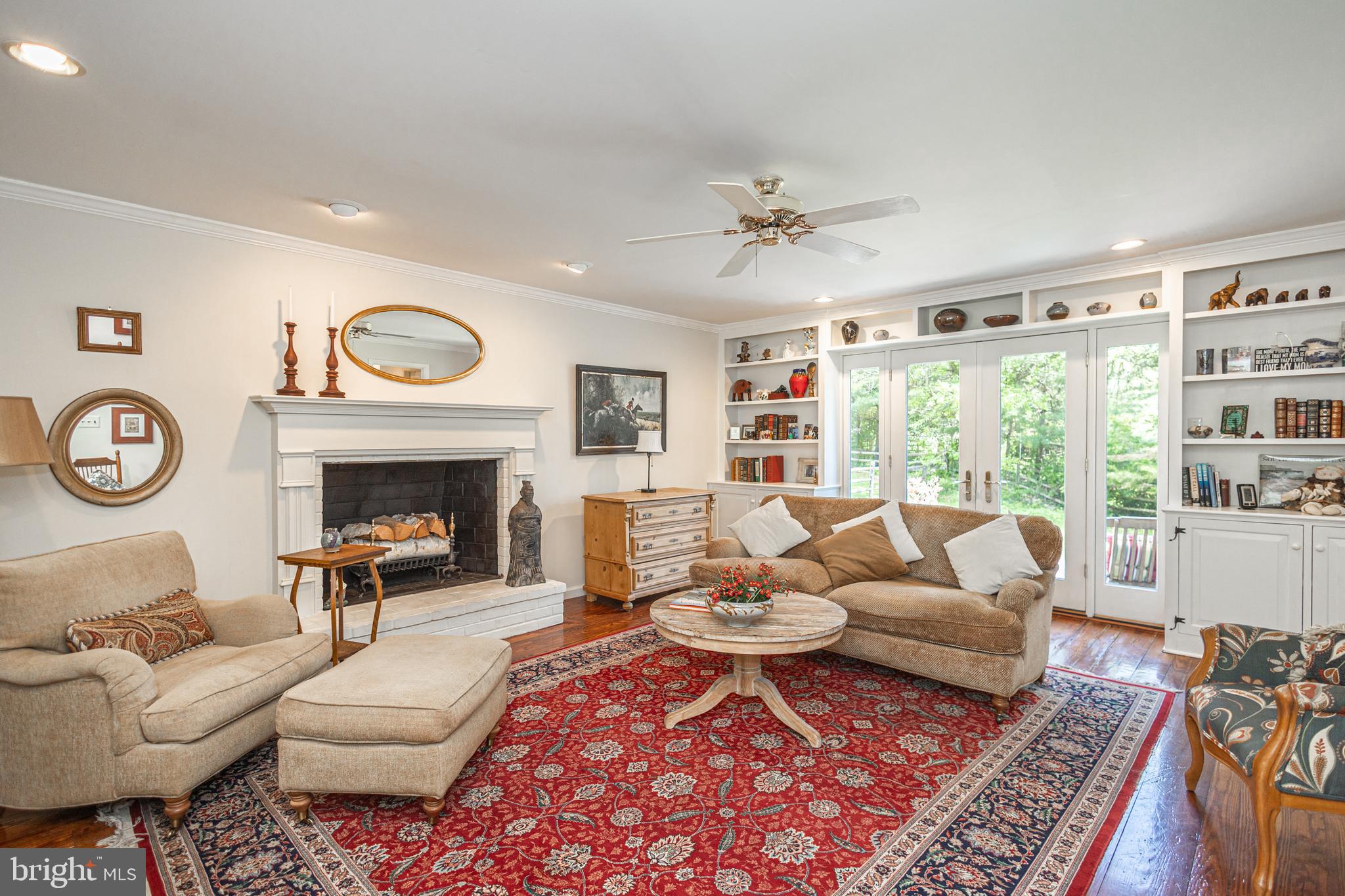 3048 Aquetong Road New Hope, PA 18938 - Photo 10 of 30 a living room with furniture a rug a fireplace and a window