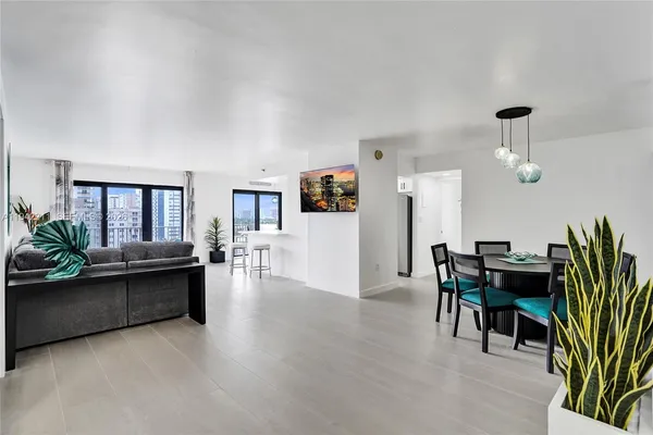 a view of a livingroom with furniture and a kitchen