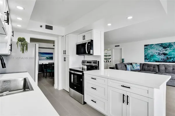 a bathroom with a granite countertop sink a large mirror and shower