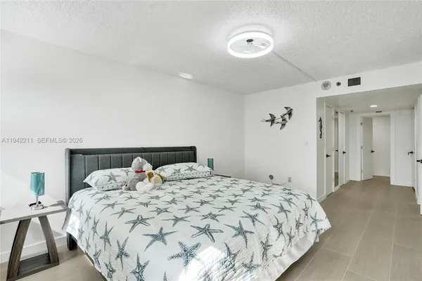 a bedroom with a bed and a desk
