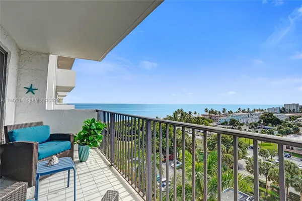 a balcony with table and chairs
