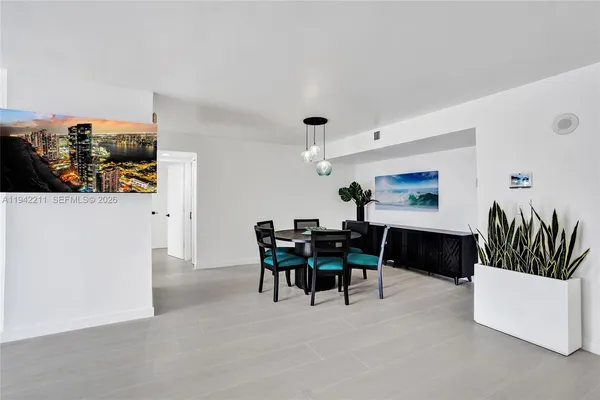 a dining room with furniture and wooden floor