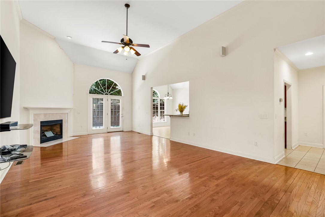 135 Sunset Bay Boulevard Seneca, SC 29672 - Photo 9 of 50 A living room showcasing an elegant fireplace, vaulted ceilings, and rich hardwood flooring.