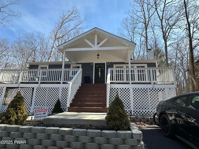a front view of a house with iron fence