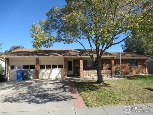 front view of a house with a tree
