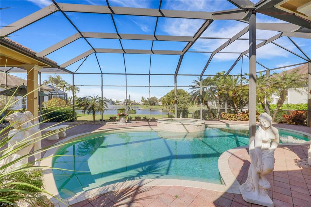 435 Terracina Way Naples, FL 34119 - Photo 31 of 50 View of swimming pool featuring a sunroom, a pool with connected hot tub, and glass enclosure