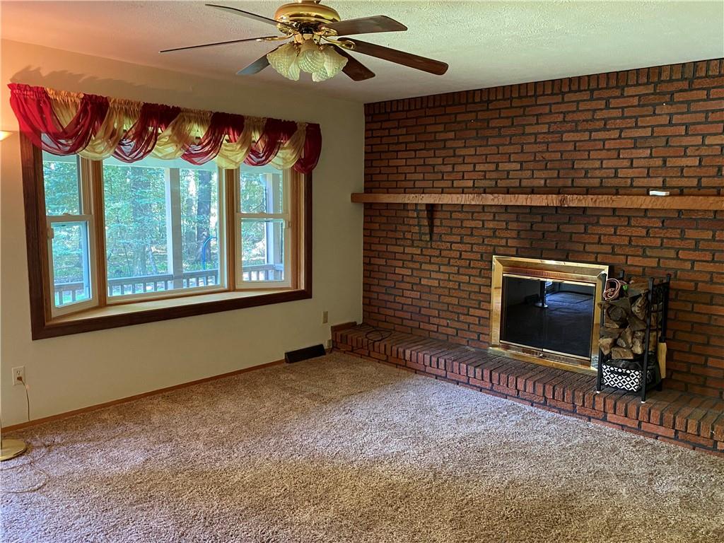352 Barron Road Slippery Rock, PA 16057 - Photo 8 of 22 a view of an empty room with a fireplace and a window