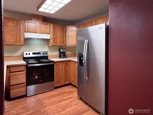 a kitchen with a refrigerator sink and stove