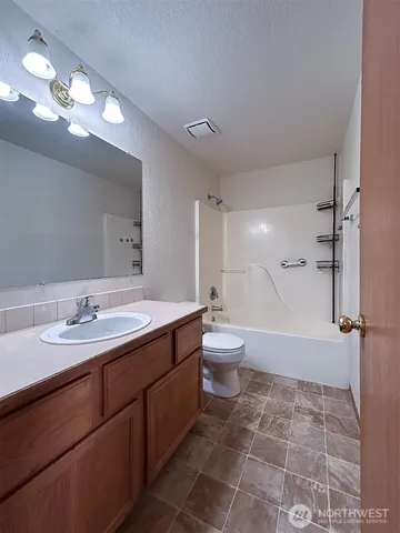 a bathroom with a double vanity sink toilet and shower