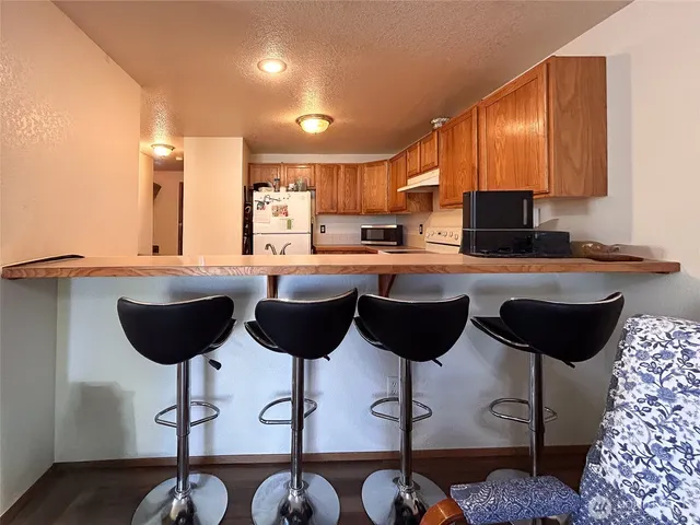 a kitchen with a dining table and chairs