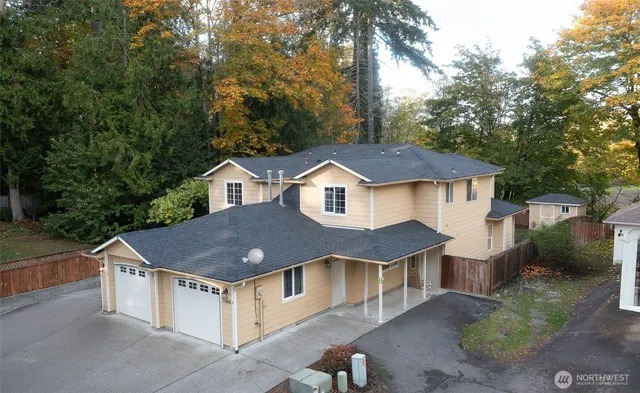 a aerial view of a house next to a yard
