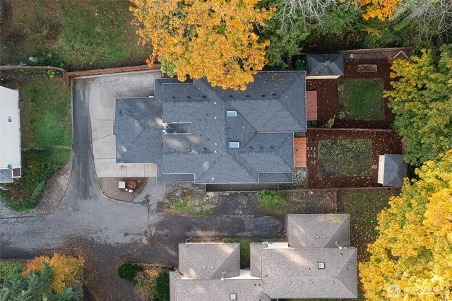 an aerial view of a house with a yard