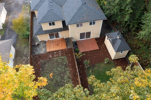 an aerial view of a house with garden space and street view