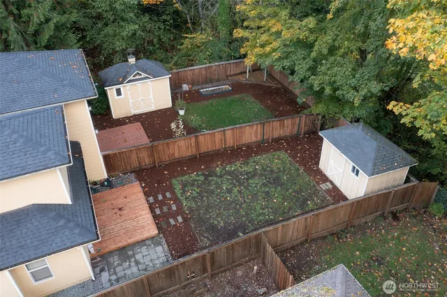 an aerial view of a house with a yard