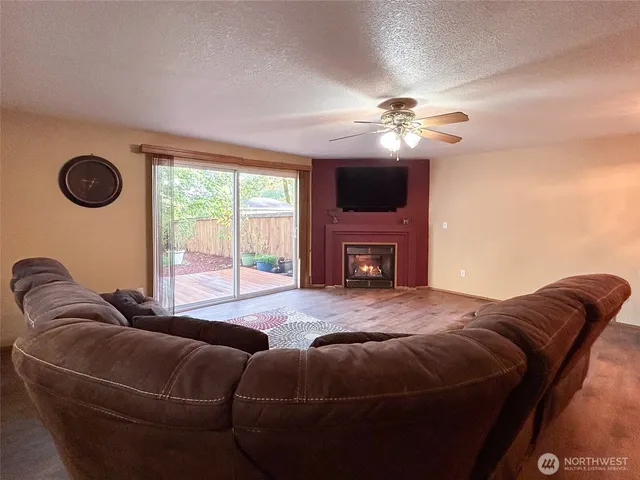 a living room with furniture a fireplace and a flat screen tv