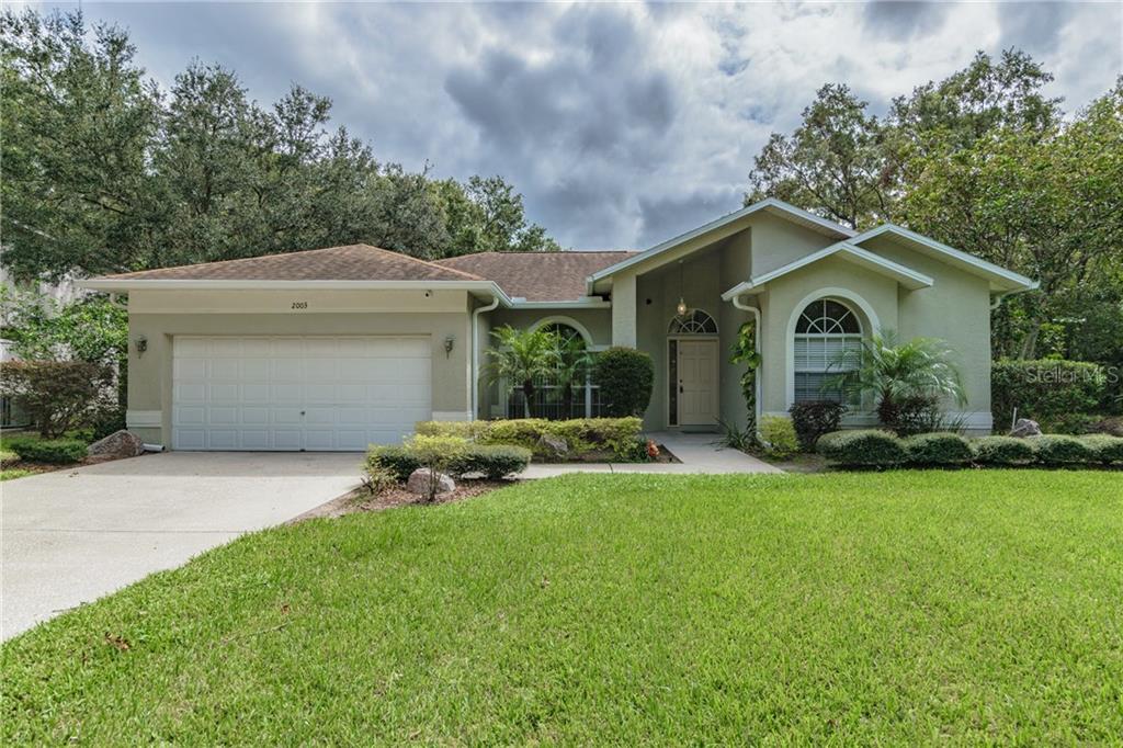 2003 Shadow Walk Palm Harbor, FL 34685 - Photo 1 of 1 a front view of a house with a garden and yard